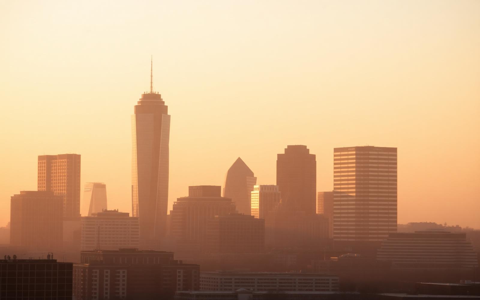 The Dallas skyline in warm haze at golden hour